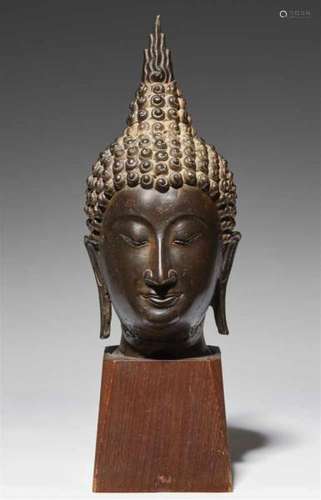 A Sukhothai style head of a Buddha. Thailand. 15th century or laterA narrow and [...]