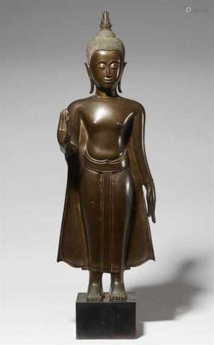 An Ayutthaya bronze Buddha. Thailand. Probably 17th centuryStanding wearing a tightly [...]