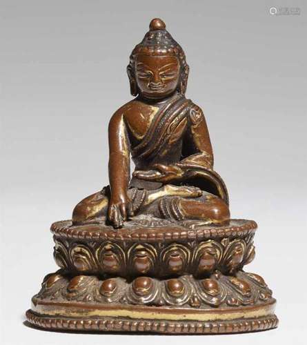 A small Nepalese bronze figure of Buddha Shakyamuni. 14th centurySeated in dhyanasana [...]