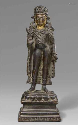 A rare Kashmiri or Western Tibetan silver-inlaid dark bronze figure of the crowned [...]