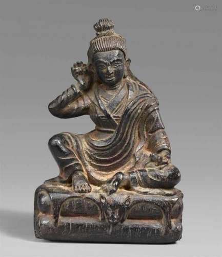 A Tibetan wooden figure of Milarepa. 18th/19th centurySeated in lalitasana on an [...]