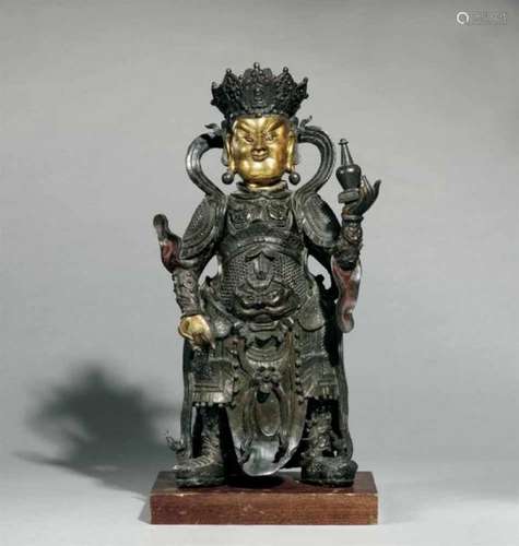 A partly gilt bronze figure of a guardian (vajrapani). 17th/18th centuryStanding with [...]