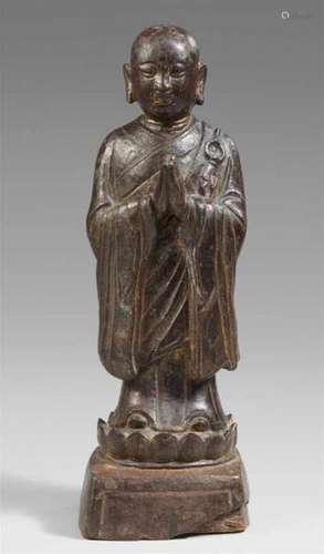 A lacquered bronze figure of luohan Ananda. Ming dynastyStanding on a lotus blossom [...]