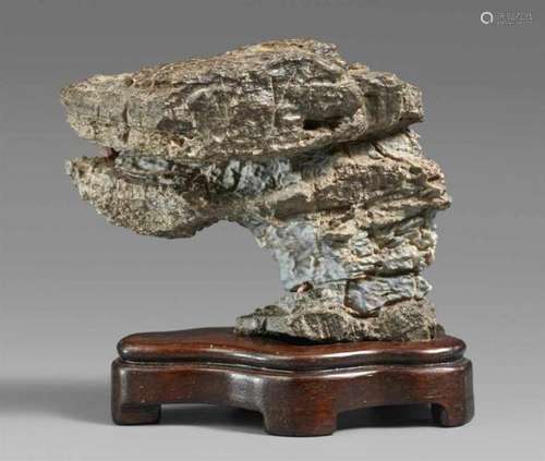 A small scholar's rockLayered and with inclusions, of overhanging shape. Wooden [...]