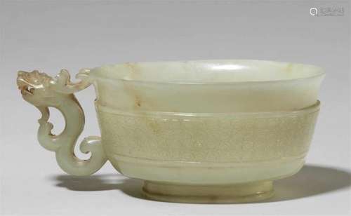 A finely carved celadon jade handle cup. 17th centuryThe ovoid and deep bowl rising [...]