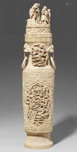 A tall ivory vase. Early 20th centuryCarved from one single tusk, to the neck two [...]