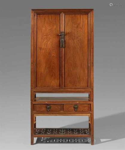 A huanghuali cabinet in two partsA cabinet on four feet with decorative spandrels, [...]