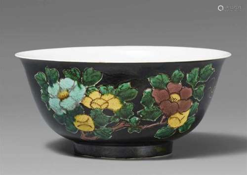 A famille nore bowlA deep bowl with everted rim, decorated on black grund with [...]