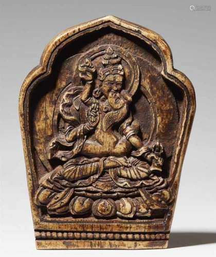 A Nepalese bone relief with VajrasattvaThe relief in the form of a lotus leaf, carved with