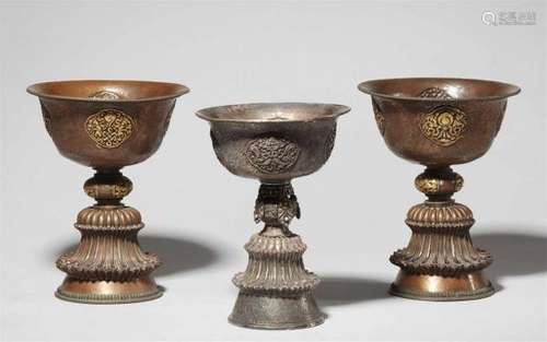 A Tibetan silver butter lamp and a pair copper butter lampsThe bell-shaped base [...]