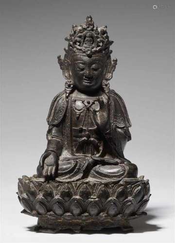 A bronze figure of Guanyin. 17th/18th centurySeated in meditation on a separately [...]