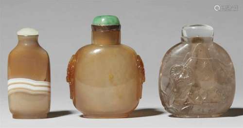 Three Snuff bottles. 19th / 20th centuryOf a) honey-coloured stone with a central [...]