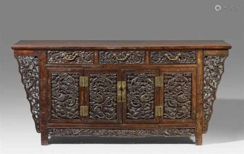 A very large hardwood sidebord. Late 19th/early 20th centuryOn four low feet, behind [...]