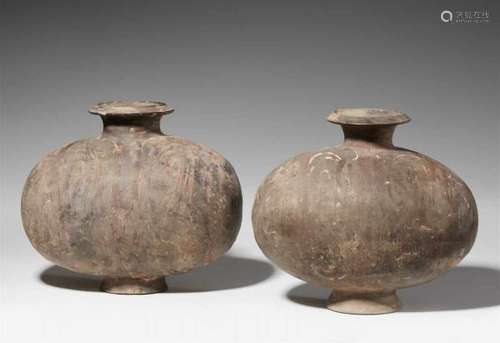 Two grey earthenware cocoon jars. Han dynasty (206 BC-220 AD)With traces of red and white