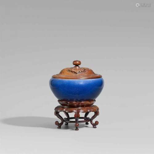 A blue-glazed incense burner in alms bowl form. 19th centuryOf bulbous form on three [...]