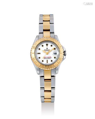 Rolex. A Lady's Yellow Gold and Stainless Steel Wristwatch with Bracelet and Date