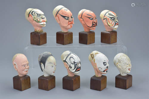 Nine early 20th century Chinese Painted Pottery Heads of Theatrical Men on wooden stands, average 5c