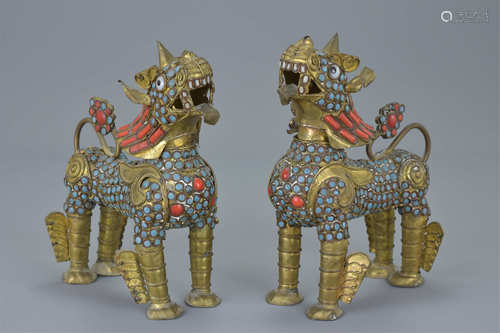 Pair of Cambodian Metal Lions inset with Coloured Stones, 14cms high (2)