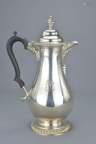 An English sterling silver coffee pot with wooden handle. Hallmarked and dated 1934 London, Maker Ja