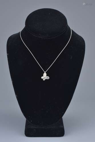 A 14K white gold necklace with sapphire butterfly pendant