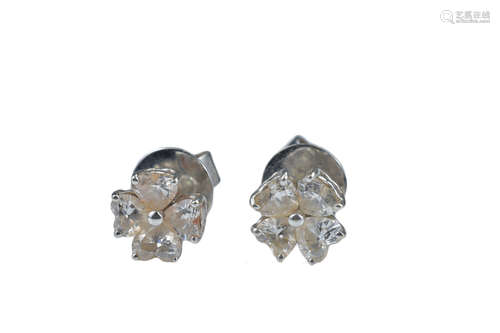 A pair of diamond stud earrings each with four hea