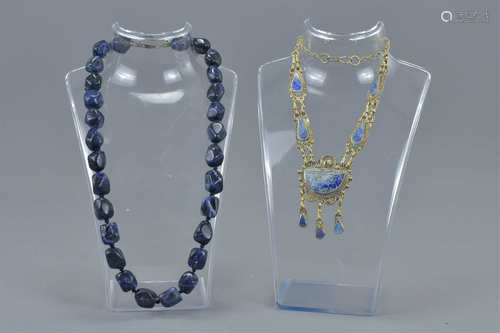 A large lapis lazuli beaded necklace together with one white metal and lapis stone necklace (2)