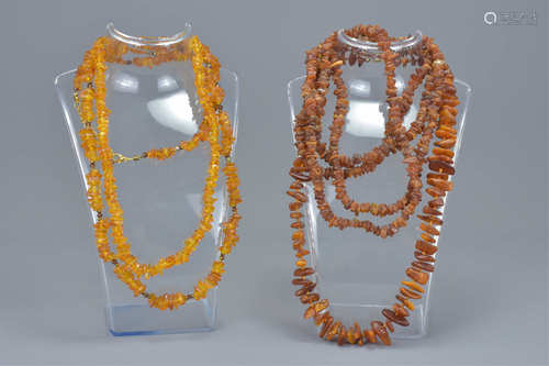 A group of four strung amber chip bead necklaces. (4)