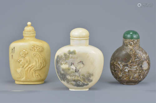 Three Chinese 19th century Snuff Bottles including a Fossilized Stone example and Two Ivory Examples