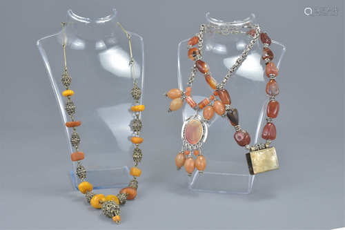 Three vintage agate, amber and white metal necklaces. (3)