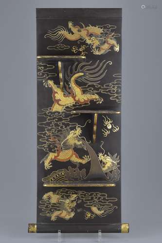 A Chinese early 20th century painted lacquer wall hanging with folding shelves decorated with dragon