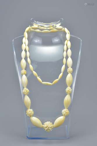 19th century Ivory Bead Necklace with Seven Ivory Spacer Beads in the form of Flowers, approximately