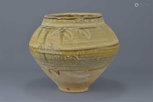 A Chinese 12/13th century pottery jar with unusual glazing. Decorated with floral motifs and a brown