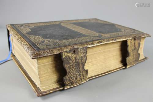 An Early 20th Century Bible; the Bible having gilt brass clasp and decorative gilded decoration