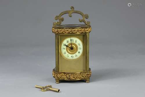 A French Brass Carriage Clock, have bevelled glass panels, ivorine enamel face with numeric dial, brass scrolling fascia, platform escapement stamped SFRA with oval glass viewing platform, approx 9 x 12 x 6 cms with decorative carry handle, complete with winding key