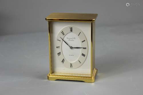 A Gilt Brass Clock, retailed by Garrard & Co London, the clock have a Quartz movement, approx 10 x 13 x 6 cms, brushed steel dial with Roman numerals