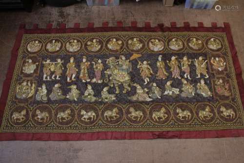 A Large Antique Indonesian Wall Tapestry, the tapestry intricately worked with sequins and beads, depicting figures and elephants, surrounded by a border of temple guards and horses, approx 260 w x 120 h