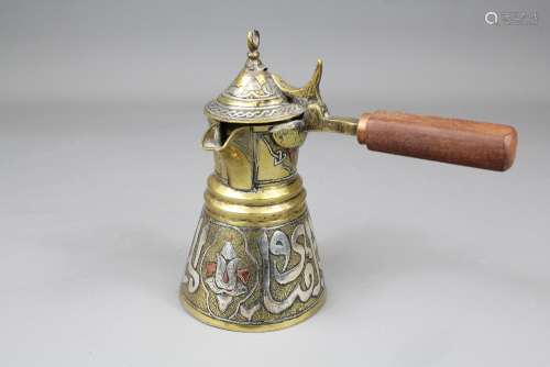 A Cairo-ware Coffee Pot; with wooden handle, approx 15 cms h, with silver Islamic script inlay