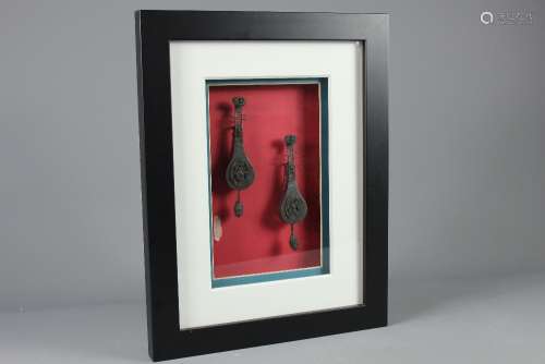 A Pair of Bronze Chinese Miniature Belt Loops in the form of Ruan, housed in a box frame, approx 35 x 45 cms