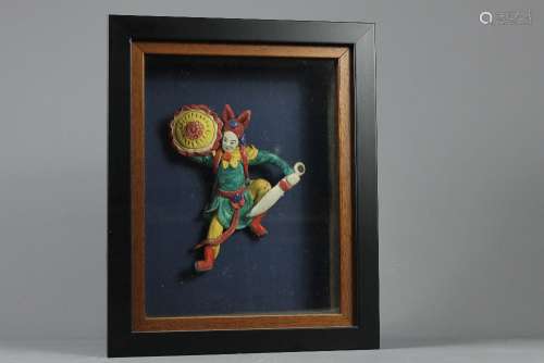 A Ceramic Chinese Theatre Actor, in an aggressive pose, with a sword and shield, housed in a box frame measuring approx 30 x 37 cms