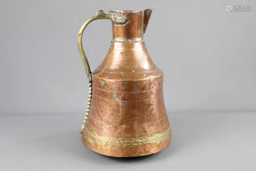 A Middle Eastern Copper and Brass Ewer; the ewer having decorative piercing to the handle, approx 33 cms h
