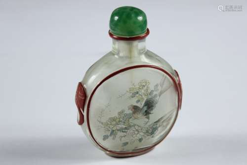 An Antique Chinese Glass Snuff Bottle; the bottle having a green jade stopper (loose), hand painted with a rock garden and bird, a cockerel to the reverse, approx 9 x 6 cms