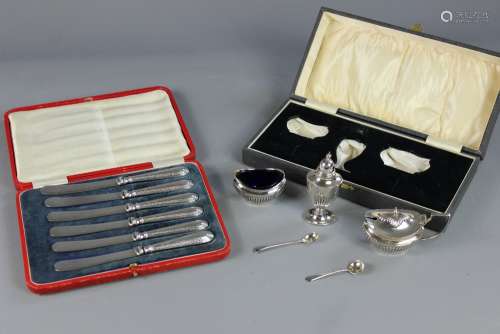 A Boxed Silver Cruet, Birmingham hallmark, dated 1922, comprising salt, pepper, mustard complete with blue liners and associated salt and mustard spoons together with silver handled butter knives, Sheffield hallmark, dated 1915, contained in the original box
