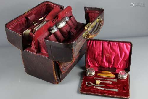 A Mappin and Webb, London Red Leather Gent's Grooming Case; the case containing three bottles with tops, glove stretchers