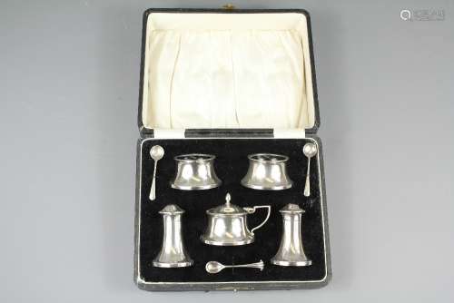 A Boxed George V Silver Cruet Set, comprising two salts, two peppers, mustard and associated spoons, Birmingham hallmark, dated 1932