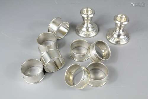 A Pair of Silver Travelling Candlesticks, together with eight silver napkin rings, various hallmarks