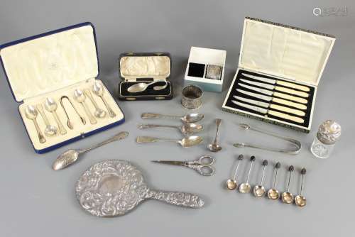 A Quantity of Miscellaneous Silver, this lot comprises, a boxed set of silver coffee spoons and sugar nips, Sheffield hallmark, mm Mappin & Webb, dated 1937, monogrammed B, a boxed silver Christening spoon Sheffield hallmark, boxed silver napkin rings Birmingham hallmark, three silver tea spoons (various hallmarks), sewing scissors, sugar tongs, Georgian silver mustard spoon, five silver coffee-bean finial spoons, a silver jam spoon, a silver hand-mirror, a box of steel butter knives and a silver topped scent bottle