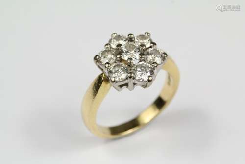 An 18ct Yellow Gold Diamond Ring, the floral ring set with a center diamond of approx 33 pts and surrounded by six  diamonds of approx 25 pts of dias, size O, approx 7