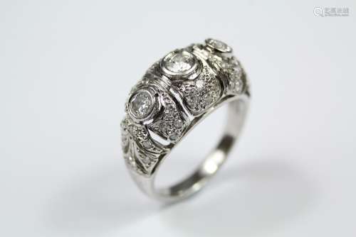 A Lady's Platinum and Diamond Russian Dress Ring, the ring set with 1 x 18 pts and 2 x 16pts of dias, on a fretwork floral mount and further set with 55 pts of pave-set dias, size N, approx 8