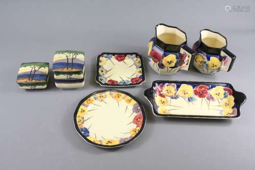 Royal Doulton Pansy Pattern Porcelain; comprising two milk jugs, four tea cups, two coffee cans, sandwich serving plate, cake plate, two 21 cms plates, one 24 cms plate, 4 19 cms plates, one square 15 cms plate and two Royal Doulton trinket dishes with covers