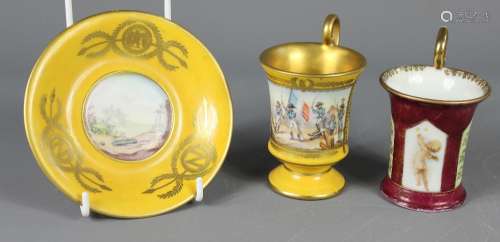 A French Porcelain Cup and Saucer, in the Napoleonic/Empire-style, hand painted with a battle scene, high scrolled handle, heightened with gilt and a gilded interior, bears the marks for Porcelaine de Paris together with another cup hand painted with a cherub capturing butterflies